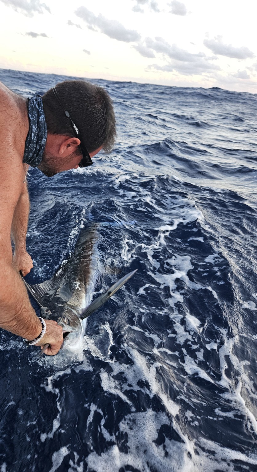 Captain releasing a fish back into the sea